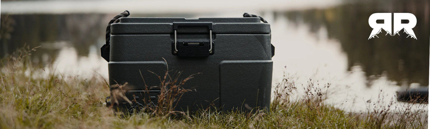 Cooler Sitting in the grass by a pond