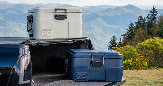 Two coolers sitting on a truck bed