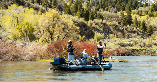 three people fishing from a boat