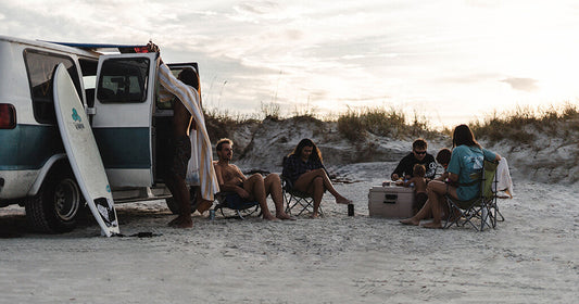 group of people camping on a beach